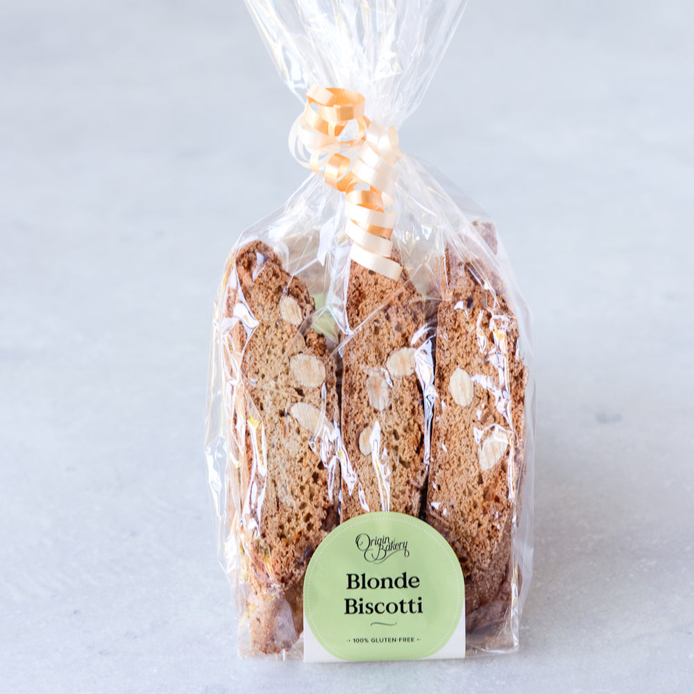 package of 6 gluten free almond orange biscotti in compostable cellulose bag with ribbon and Origin Bakery sticker