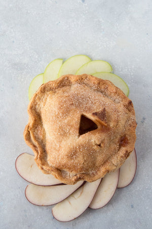 
                  
                    Load image into Gallery viewer, top view gluten free pie surrounded with sliced red green apples
                  
                