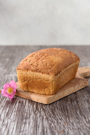 
                  
                    Load image into Gallery viewer, whole loaf gluten free Vega Bread on board with flower
                  
                