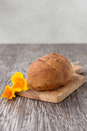 
                  
                    Load image into Gallery viewer, whole loaf gluten free White Sourdough on wood board with flower
                  
                