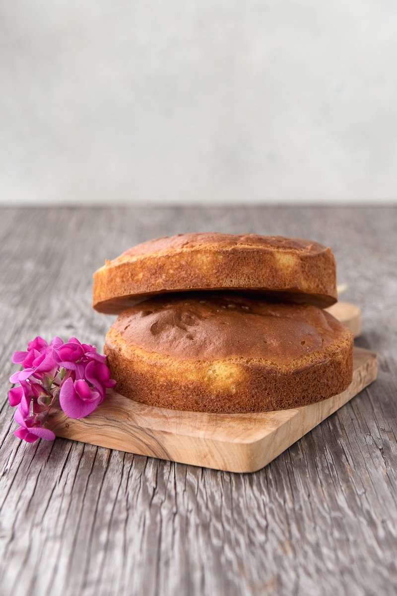 stack 2 whole gluten free focaccia bread rounds with flowers on wood board