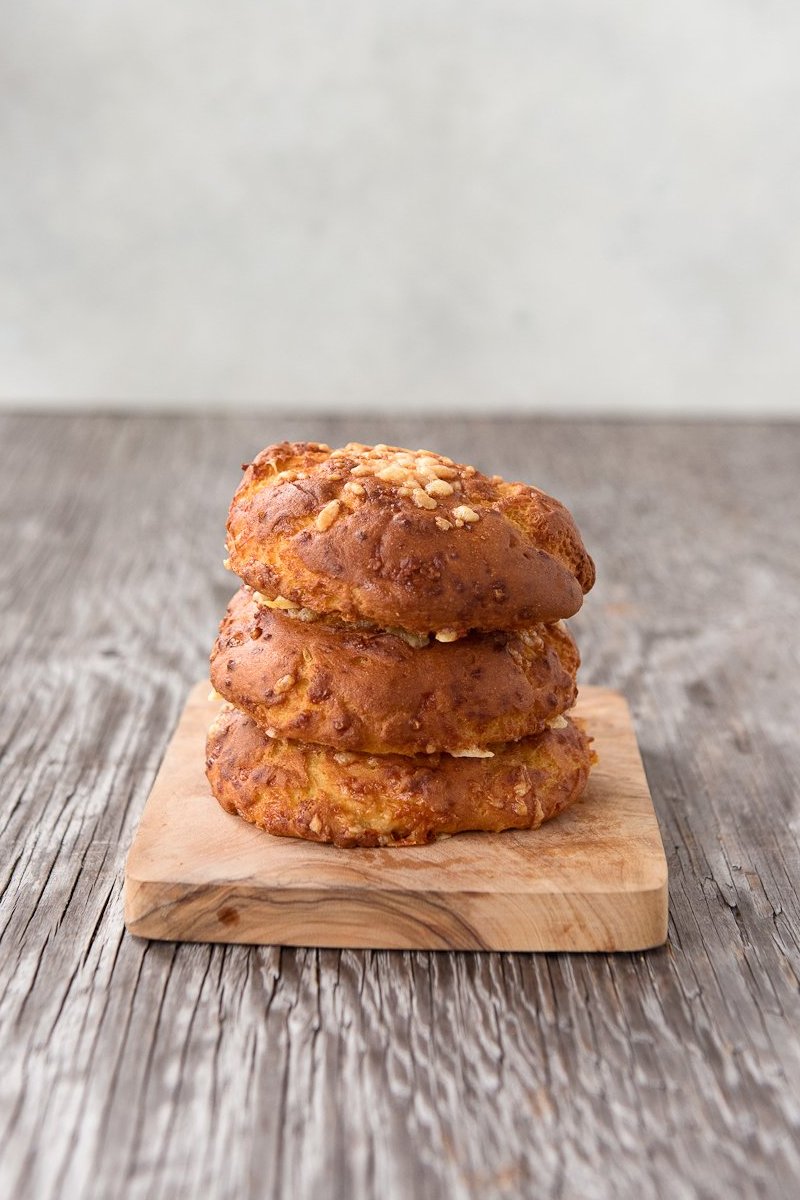 vertical stack 3 gluten free cheese buns on cutting board