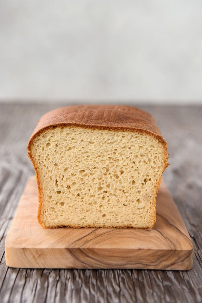 cut face view gluten free Spring Bread on wood board, white sandwich bread, dairy-free