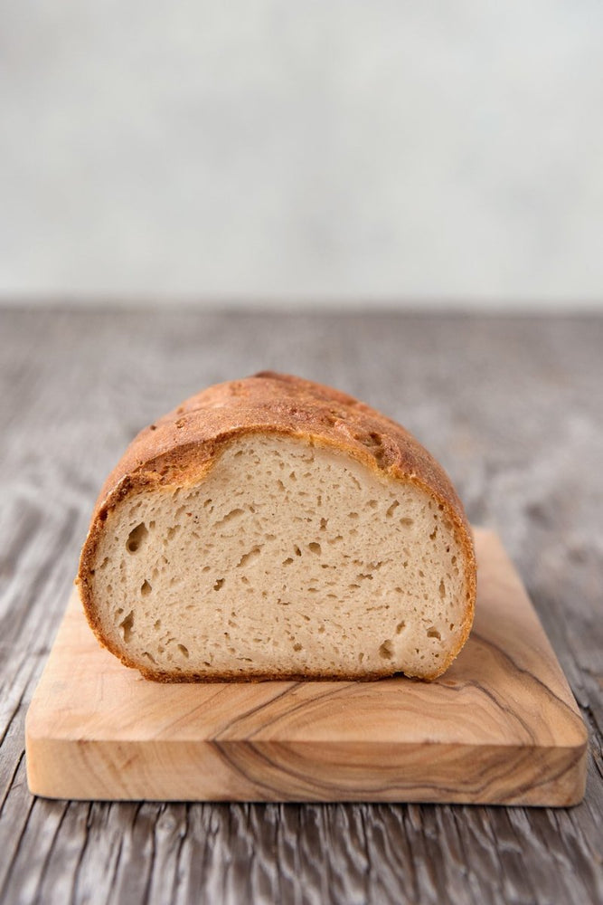 cut face view gluten free White Sourdough on wood board, dairy-free egg-free