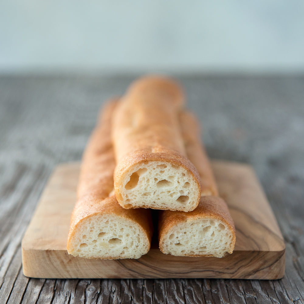 3 gluten free baguettes cut face on cutting board