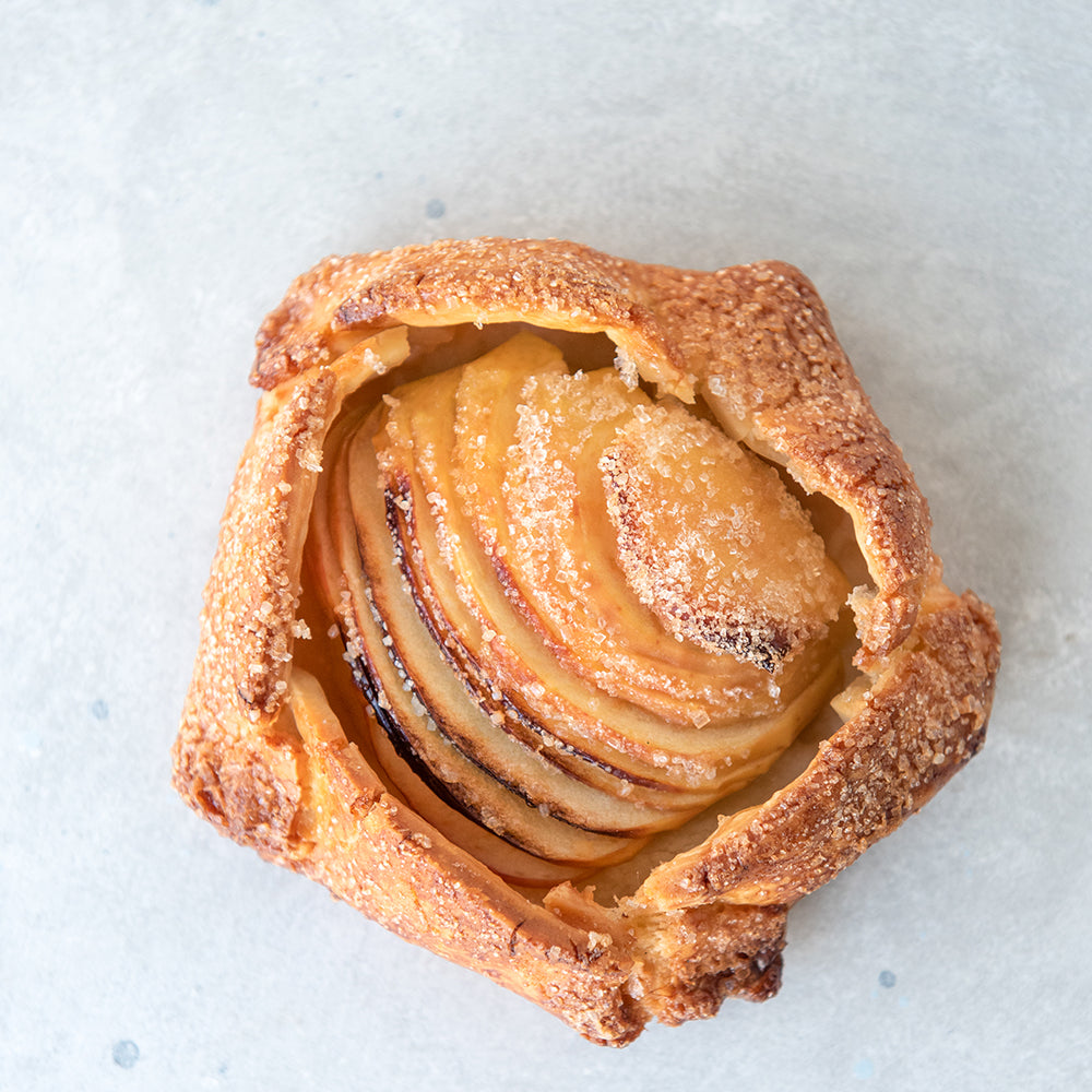 top view gluten free galette pastry with sliced apple on top of almond frangipane