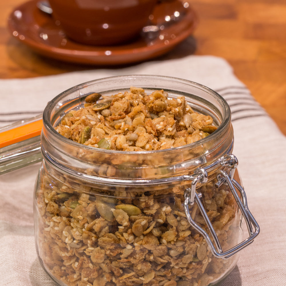 
                      
                        gluten free vegan granola in glass jar displayed with latte
                      
                    