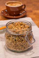 gluten free vegan granola in glass jar displayed with latte