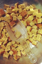 gluten free croutons in metal bowl with scoop