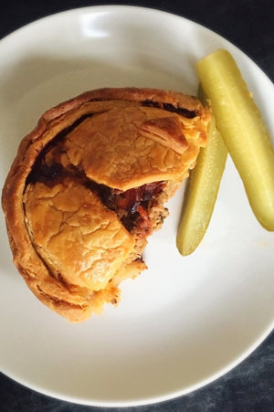 
                  
                    Load image into Gallery viewer, top view half gluten free cheeseburger pie shown with pickles on a plate
                  
                